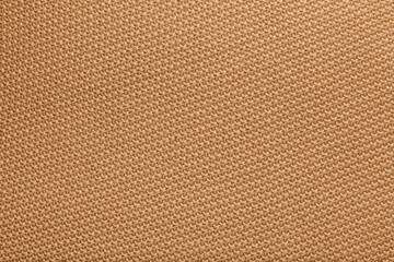 A close-up of Golden Brown Knitted Blanket Fabric Texture, the interwoven yarn creates a warm, cozy appearance, with visible knit stitches and a soft, inviting feel.
