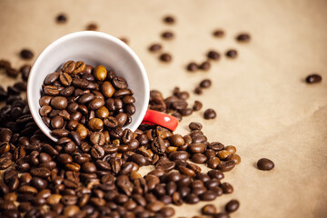 red cup with coffee beans on a light background.