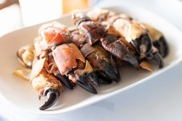 Steamed stone crab claws served with a spicy seafood dipping sauce are popular dishes in local street food in Thailand.
