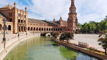 South wing of the square with the second tower and last bridge over the lake. Plaza de Espana (Spain Square), Maria Luisa Park, Seville, Spain. 