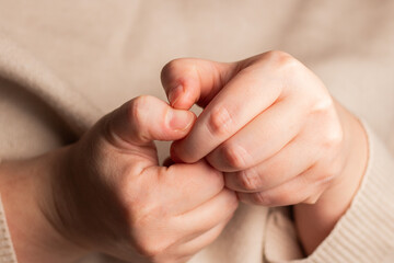 Stressed woman picking nails. Having anxiety and mental health disorder. Close up image of ugly...