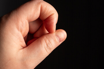 Stressed woman picking nails. Having anxiety and mental health disorder. Close up image of ugly...