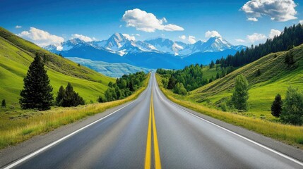 Fototapeta premium A straight highway framed by green hills and trees, with snow-capped peaks visible in the distance