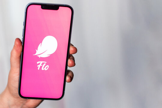 Kaliningrad, Russia 14.01.25 - Woman holding smartphone with FLO application logo on screen. Controlling woman period, ovulation, pregnancy. Female health concept.