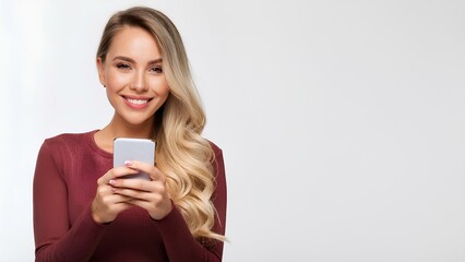 A joyful blonde girl with a smile on her face holding a mobile phone radiates happiness and excitement. The image conveys the essence of modern communication and joy in a simple, clean environment.