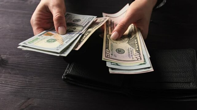Lady Calculating Her Money Savings In Us Dollar Bills