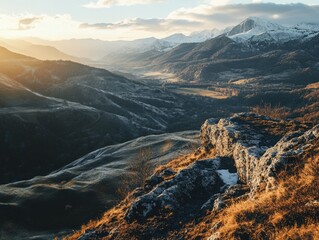 Fototapeta premium Rocky mountains and valleys under a golden sunrise.