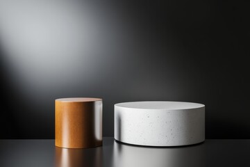 Modern minimalist display featuring a wooden and a stone circular pedestal against a dark backdrop with dramatic lighting