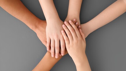  A group of hands clasped together, symbolizing unity, collaboration,