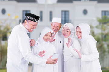 Happy Muslim Family Celebrating and Connecting Virtually Together