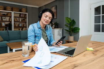 Young introvert freelancer businesswoman with ADHD working remotely from home office on laptop...