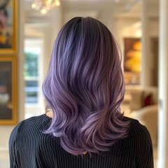 Naklejka premium A woman with beautifully styled purple hair is seen from the back, set against a softly decorated interior.