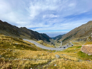 A serpentine road in the Transfăgărășan mountains. Concept of the challenge, exploration, adventure, nature, freedom, and the harmony between engineering and natural beauty.