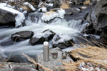 Colorful winter landscape. River in the forest in winter. Beauty of winter nature. Coffee in nature in winter. 