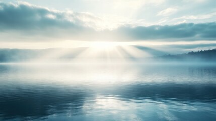 A calm lake at sunrise with light rays filtering through the mist and gently reflecting off the surface of the water, creating a serene and peaceful atmosphere.