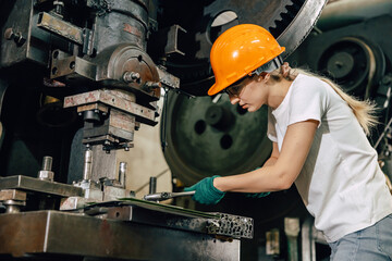 female technician worker working in heavy industry factory fixing service maintenance old machine