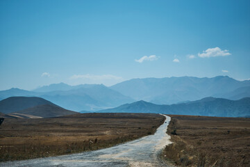 road in the desert leading to the mountains
