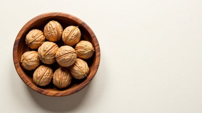 A wooden bowl overflowing with a collection of nutritious shelled walnuts, ready for snacking or culinary use.