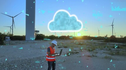 A mechanical engineer working on a laptop at a wind turbine farm, using cloud technology to monitor performance. Modern renewable energy and innovation concept - Powered by Adobe