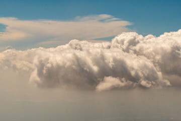 Aerial photograph of clouds outside of my airplane window on a cross country plane trip from Washington DC  to Austin Texas during a turbulent flight