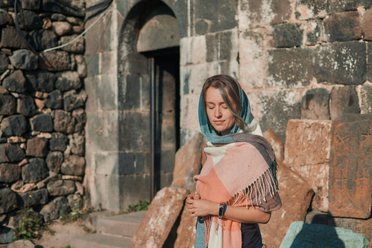 a young woman in scarf Sevanavank, monastery on lake Sevan, armenia