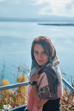 a young woman in scarf Sevanavank, monastery on lake Sevan, armenia