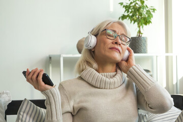 Senior woman smiling while listening to her favorite melody