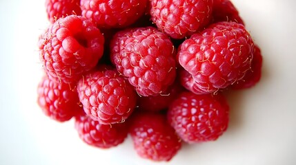 A fresh bunch of raspberries with vibrant red color and intricate details, grouped together on a white background for contrast