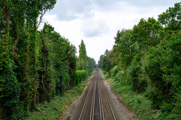 Obraz premium long straight railway track surrounded by trees Bursledon Hampshire England