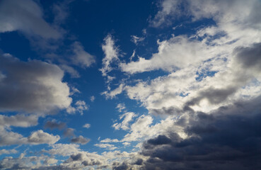 A panoramic view of gray-white clouds floating across the sky.