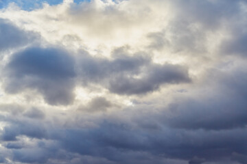 Obraz premium The sun barely breaks through the dense layer of clouds.