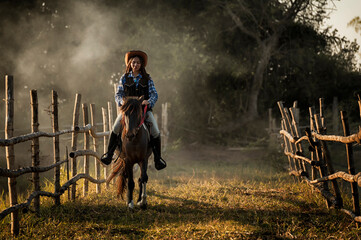woman  riding a horse in farm.