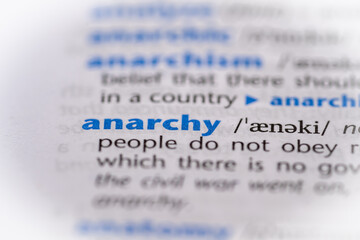 Anarchy word in a dictionary. Selective focus, close up.