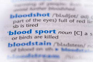Blood sport word in a dictionary. Selective focus, close up.