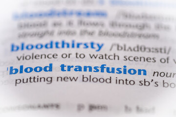 Blood transfusion word in a dictionary. Selective focus, close up.