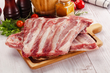 Raw pork ribs over board