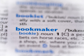 Bookmaker word in a dictionary. Selective focus, close up.