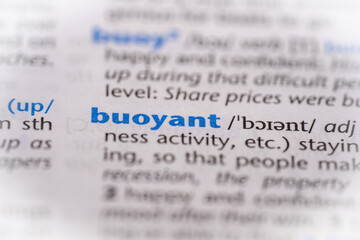Buoyant word in a dictionary. Selective focus, close up.