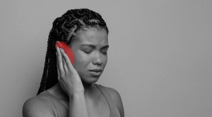 Tinnitus, ear infection. Closeup profile studio shot of sick young african woman having ear pain,...