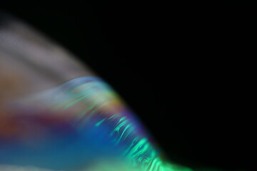 Bright multicoloured liquid sphere on black background 