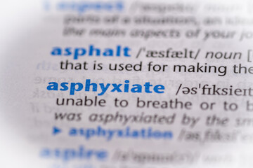 Asphyxiate word in a dictionary. Selective focus, close up.