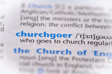 Churchgoer word in a dictionary. Selective focus, close up.