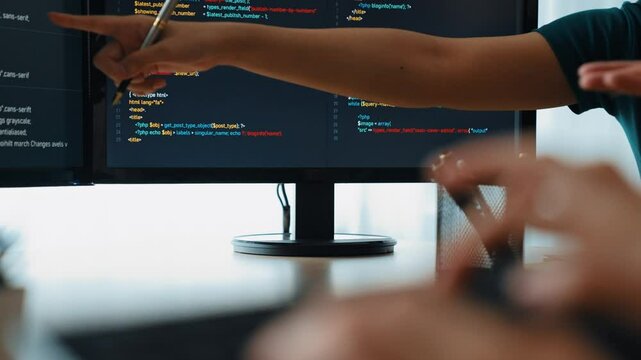 Closeup hand of back end software developer engineer for computer programming working together on debugging writing computing code, solving complex algorithms display on monitor. Burgeoning