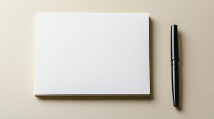 A simple setup with a blank notepad and a black pen beside it, giving a calm and organized feel. 