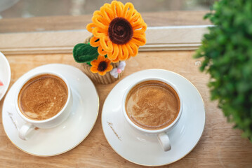 Hot coffee on the table is beautifully decorated.