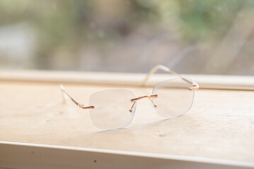 Clear glasses placed on a table next to a glass in a coffee shop.