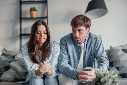 Young couple arguing and talking to the camera in videocall conference with specialist about relationship problems difficulties. Sad and angry man and woman arguing indoor debating future
