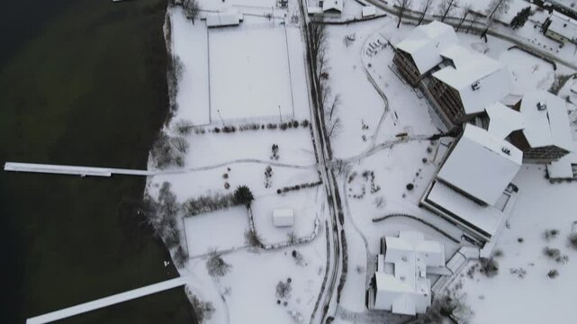 Aerial View to Lake Fuschl, Fuschlsee, Salzburg, Austria, Winter, Aerial drone video of the Alpine mountain town of Nassereith in Austria during winter. Woods, lakes, snow.