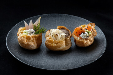 Indulge in gourmet, Asianinspired bites beautifully presented on an elegant plate. Delicious profiteroles filled with fish, pate, onions.