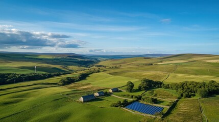 Aerial view of a green energy farm featuring wind turbines and solar panels in a rural landscape